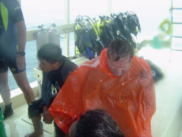 New Friend Mark dons a poncho.. wait.. he just got out of the water and still has on his wetsuit.