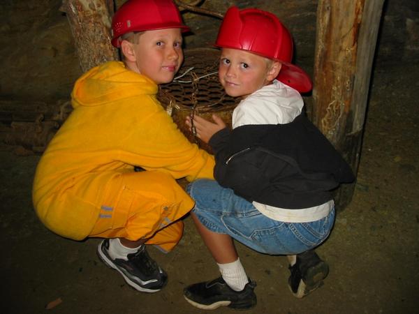 Cousins rub the "lucky bucket" (used by miners for good luck)