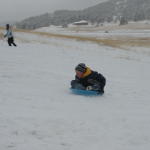 Fresh snow makes for great sledding at Meyer's Ranch park.  Isaac uses a saucer on this run.