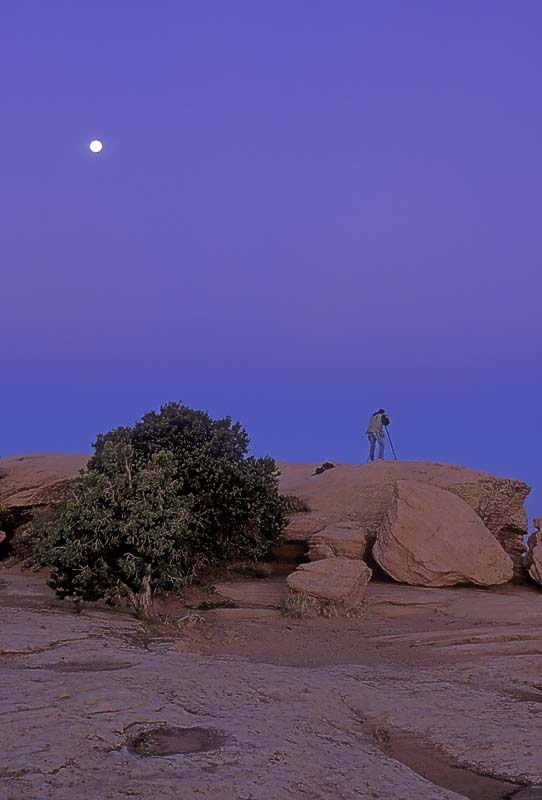 Photographer at Sunrise.  Canyon de Chelley.  Full Moon setting.  F100, 17-35mm.