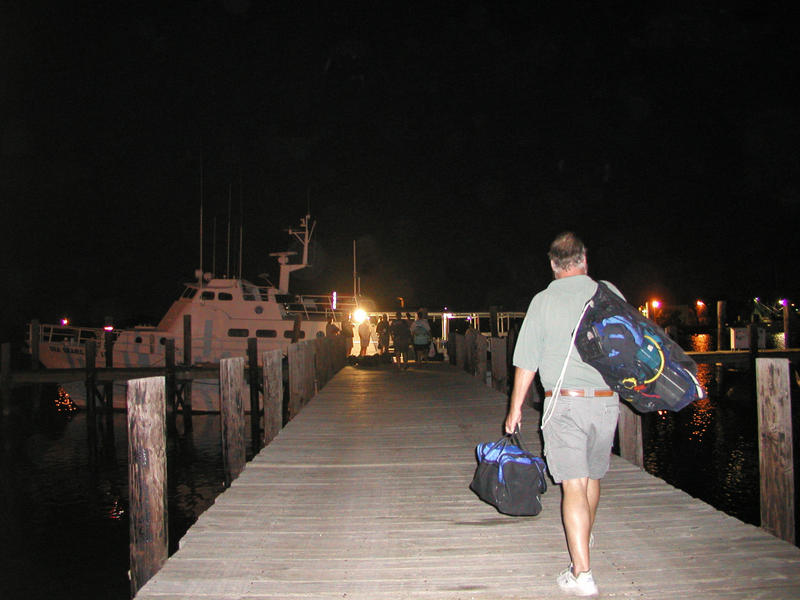 Miles carrying his gear to the ship.