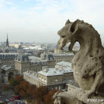 Stone chimera on the railing of the gallery that circles and connects the towers of the facade of Notre-Dame Cathedral.