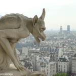 Stone chimera on the railing of the gallery that circles and connects the towers of the facade of Notre-Dame Cathedral.