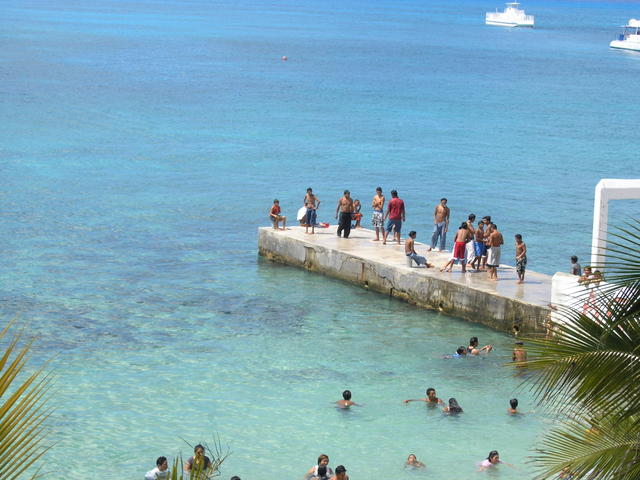 sunday with no cruise ships in town. the shops are closed and the locals are taking a dip! Mostly kids and some parents.