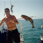 Grayson showing off 1 of the groupers Capt. Jay speared.