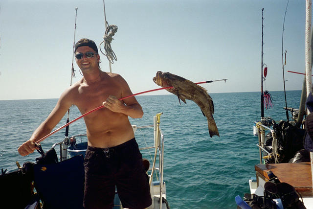 Grayson showing off 1 of the groupers Capt. Jay speared.