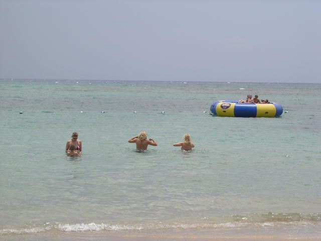 Sheryle and Anna make their way out to the water trampoline