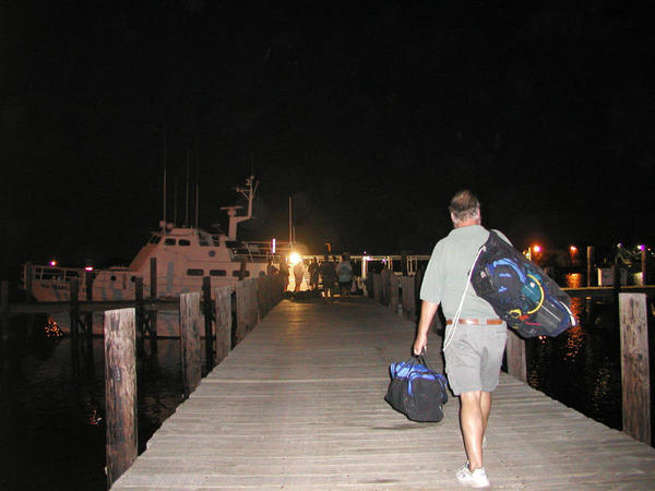 Miles carrying his gear to the ship.